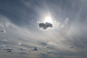 hazy sky with a backlit cloud