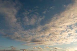 evening sky with warm sunlight reflecting on the clouds