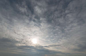 sun shining through thin layer of clouds