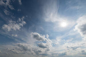 daytime sky with sun and clouds