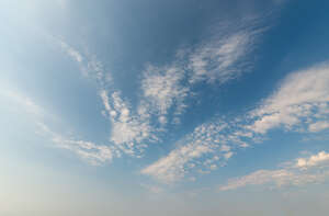 daytime sky with small thin scattered clouds