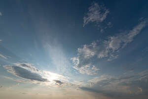 evening sky with sun and few clouds