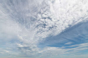 sky covered with thin small white clouds