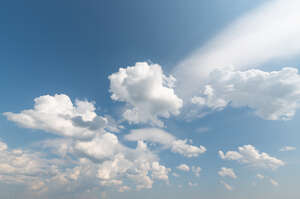 daytime sky with fluffy white clouds