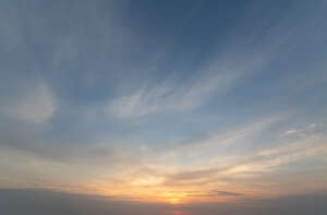 sunset with few clouds and orange sun