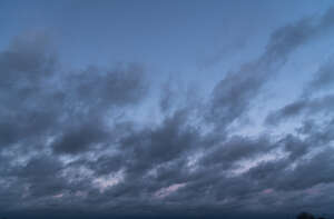 deep blue evening sky with dark clouds