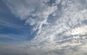 partly overcast sky with little sun visible