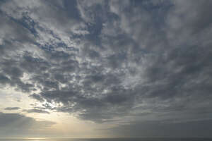 evening sky with stratus clouds and sun rays