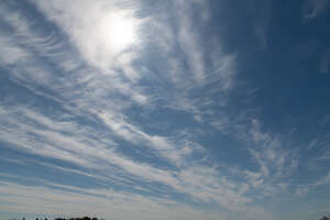 sky with cirrus clouds and sun slightly visible