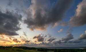 sunset with sun and large clouds