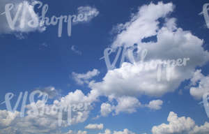 blue daytime sky with white cumulus clouds