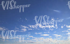 blue daytime sky with small scattered clouds