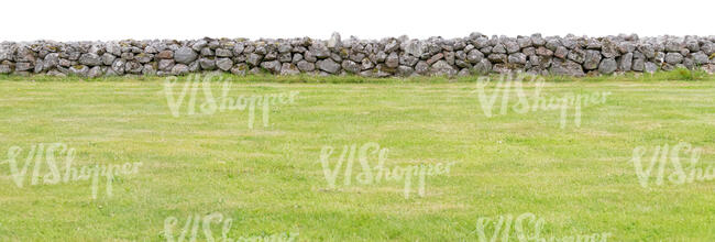 stone fence by a grass field