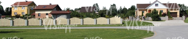 suburbian area with houses and a fence