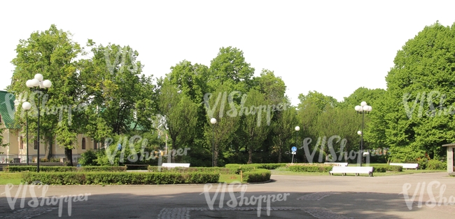 view of a park with benches and street lamps