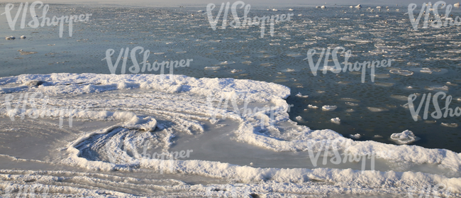partially frozen and snowy sea surface