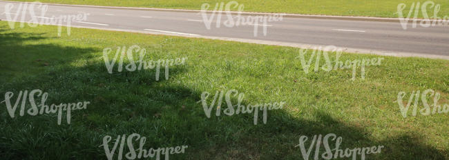 road with a front grass in shade