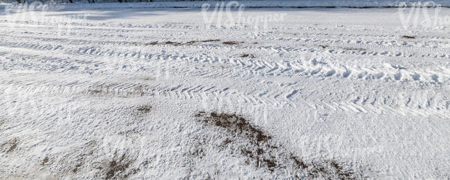 snowy road with tyre tracks