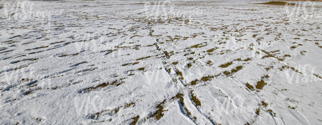 snowy beach with footprints