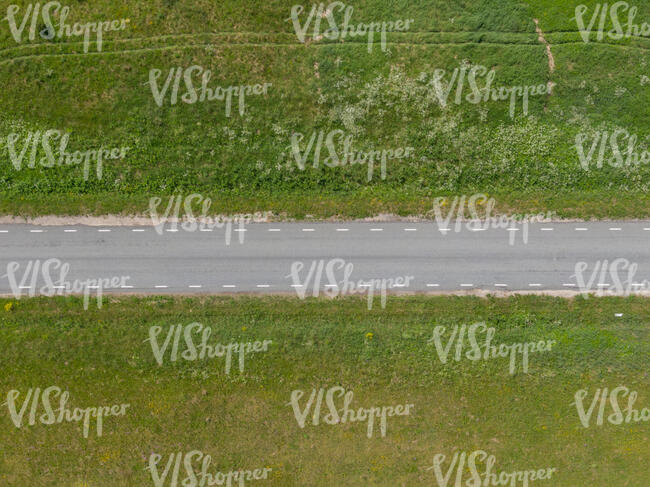 above view photo of a road between graslands