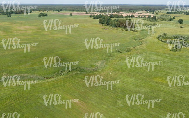 bird-eye view of a ground with river abd fields