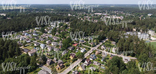 small suburb with trees and roads seen from above