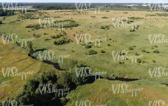 aerial view of a river running through grasslands