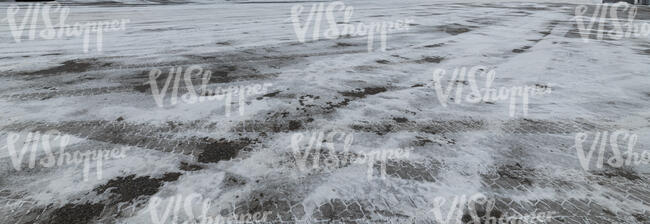 icy asphalt field with tyre tracks