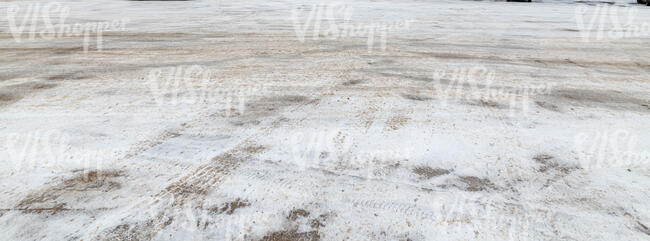 snowy parking lot ground with tyre tracks