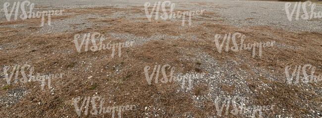 field of gravel and dry grass