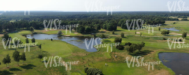 aerial view of a golf course with ponds