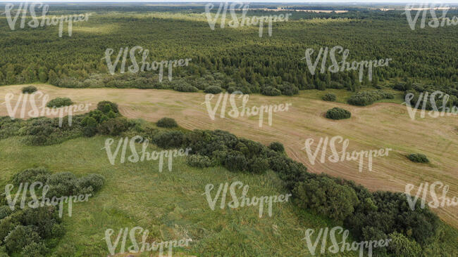 aerial view of a landscape with forests and fields