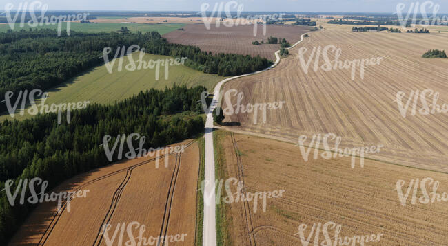 aerial view of a countryside with fieldsd and a road