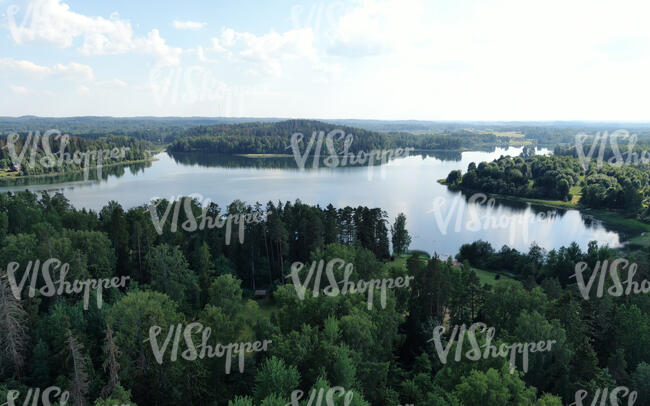 aerial view of a lake between forests
