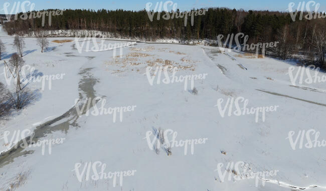 wild riverbank in winter seen from above