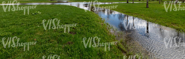 small creek between grassland