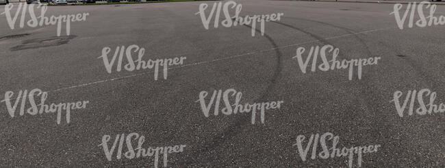 asphalt field with tyre tracks