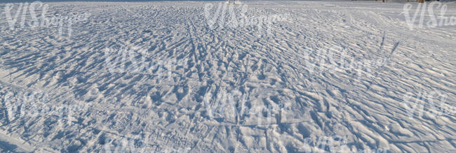 snow in sunlight with different tracks and marks