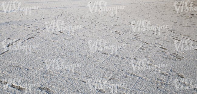 snow-covered pavement with lots of footprints