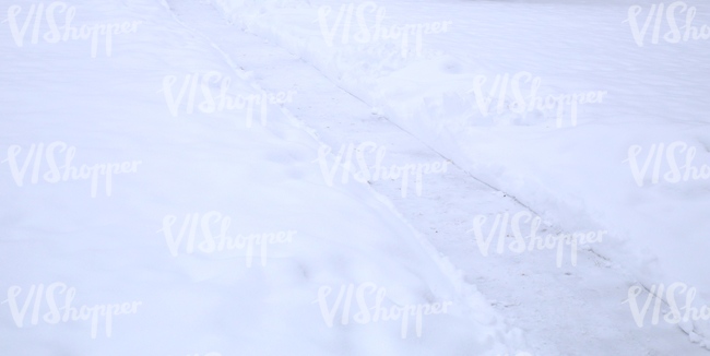 snow-covered ground with a small pathway