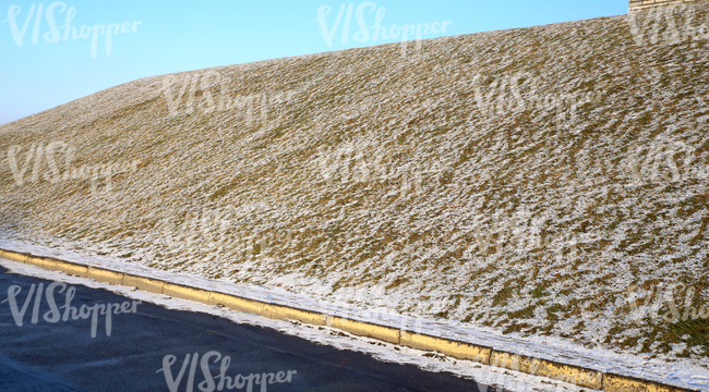 a slope partially covered with snow