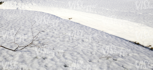 snow-covered ground with a ditch