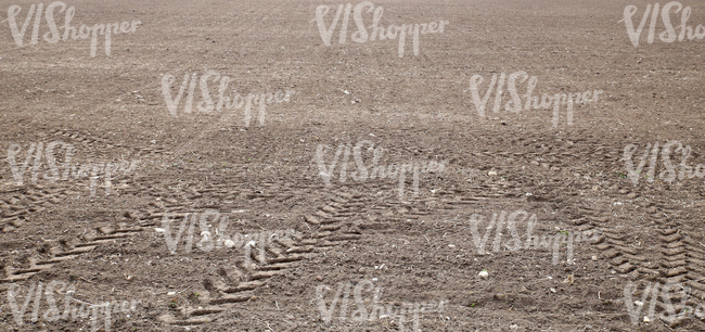 a field with tractor tracks