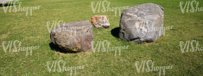 grass ground with three boulders