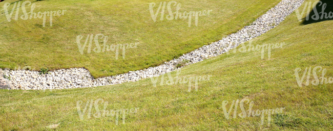 a ditch filled with rubble on sloped ground