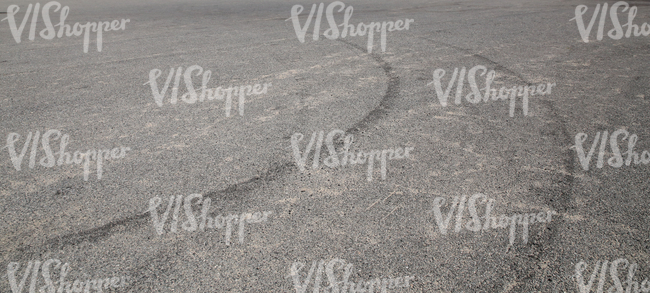asphalt ground with tyre tracks