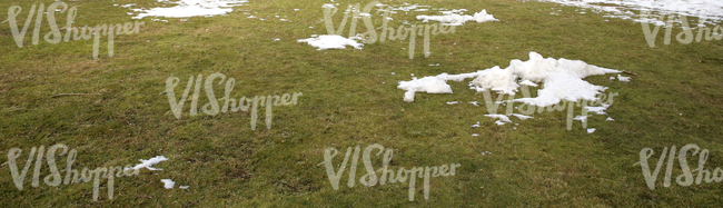 field of grass with a little bit of snow