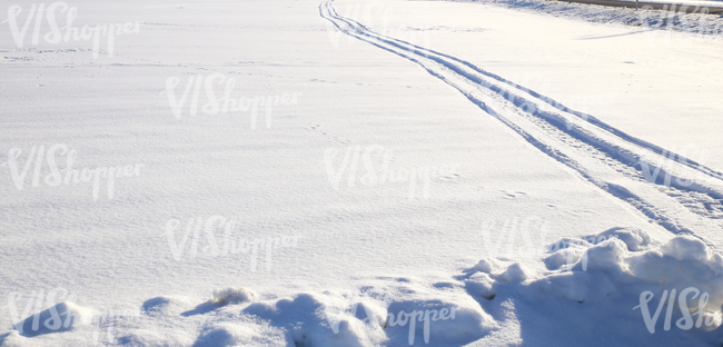 field of snow with snowmobile tracks
