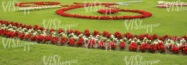 park ground with red and white flowerbeds