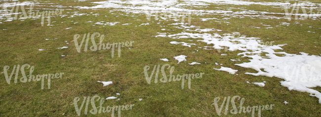 dry lawn with patches of snow